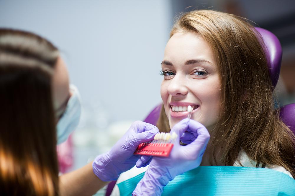 woman picking out tooth whitening shade | teeth whitening lara vic