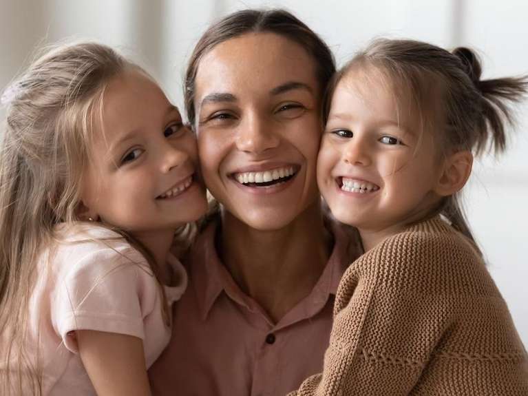 woman with two small children | cosmetic dentist lara