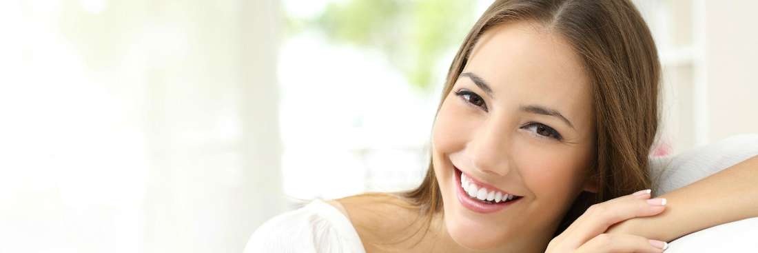 woman in white shirt smiling | lara dentists 